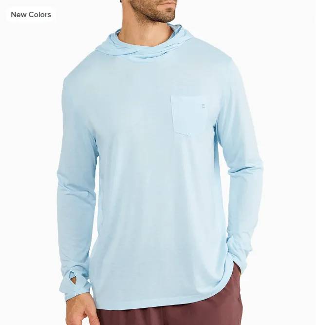 Man modeling a light blue hooded long-sleeve shirt with a chest pocket.